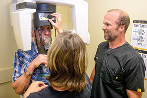 Dr. Hackney with dental assistant and Carestream CS 8100 cone beam imaging system