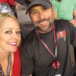 Dr. Hackney at a Tampa Bay Buccaneers football game with his wife Nicole